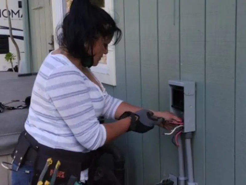 Licensed electrician wiring an exterior subpanel in Corning
